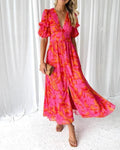 Maxi dress with puff sleeves and flowing silhouette, perfect for events.