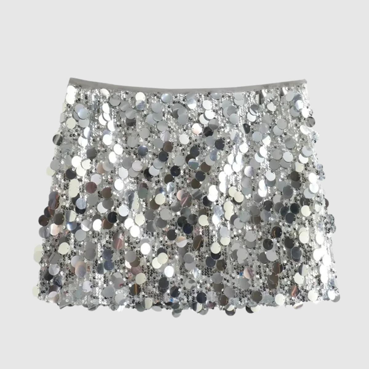 Silver sequin mini skirt with a fringe-like effect on a grey background