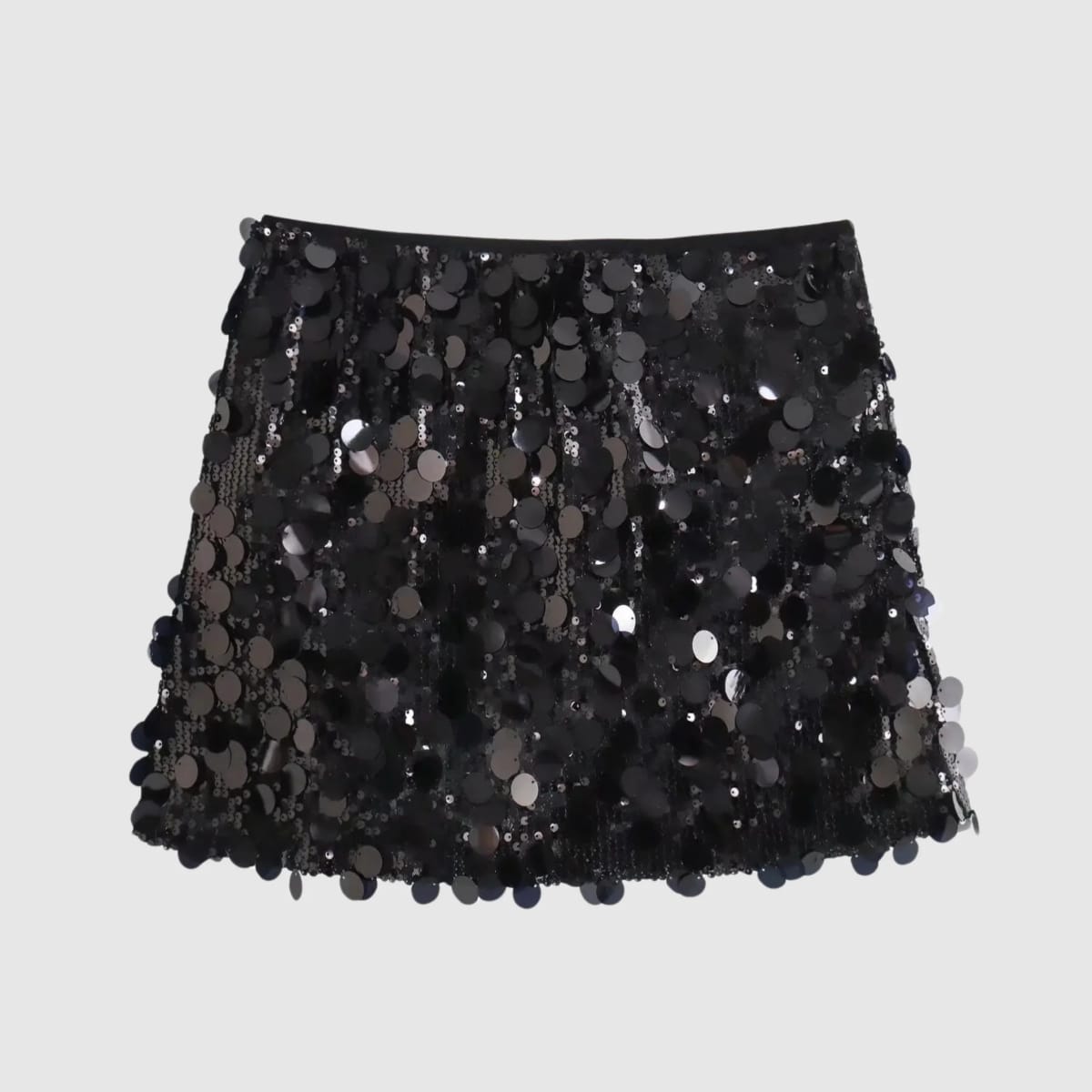 Silver sequin mini skirt with a fringe-like effect on a grey background