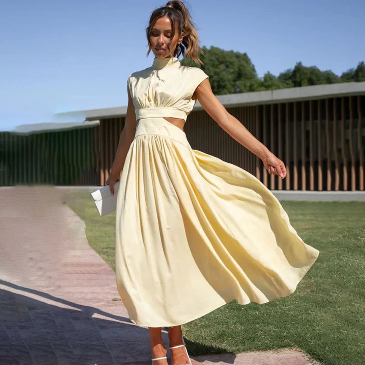 Woman wearing a halter neck flowing dress outdoors.