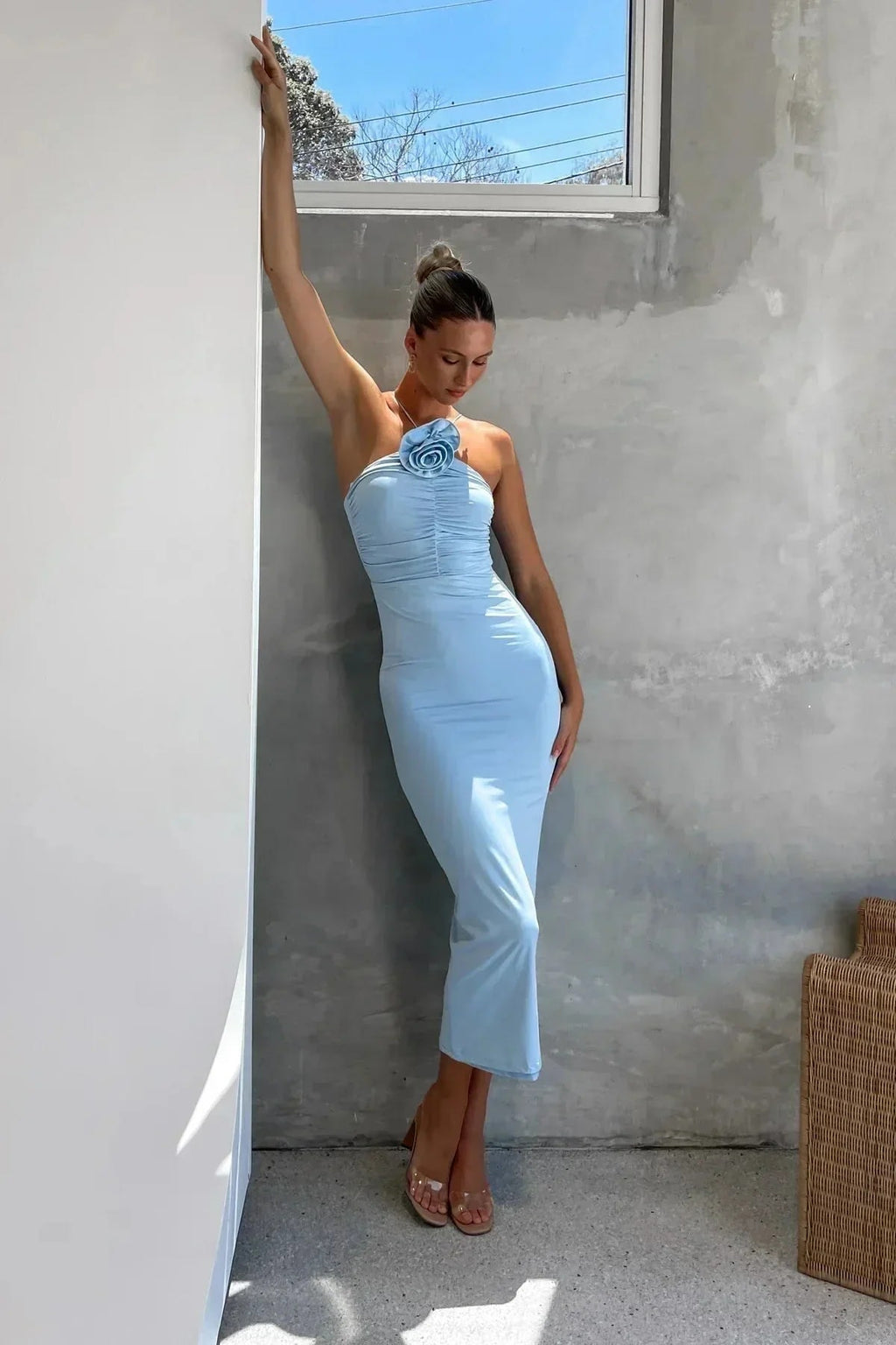 Model in bodycon midi dress with ruched bodice, asymmetric strap, 3D flower.