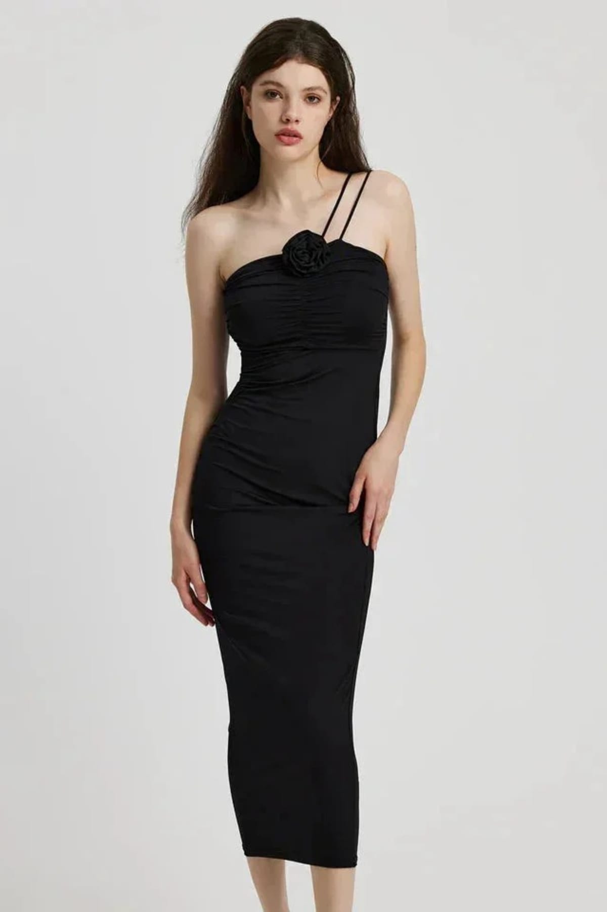 Model in bodycon midi dress with ruched bodice, asymmetric strap, 3D flower.