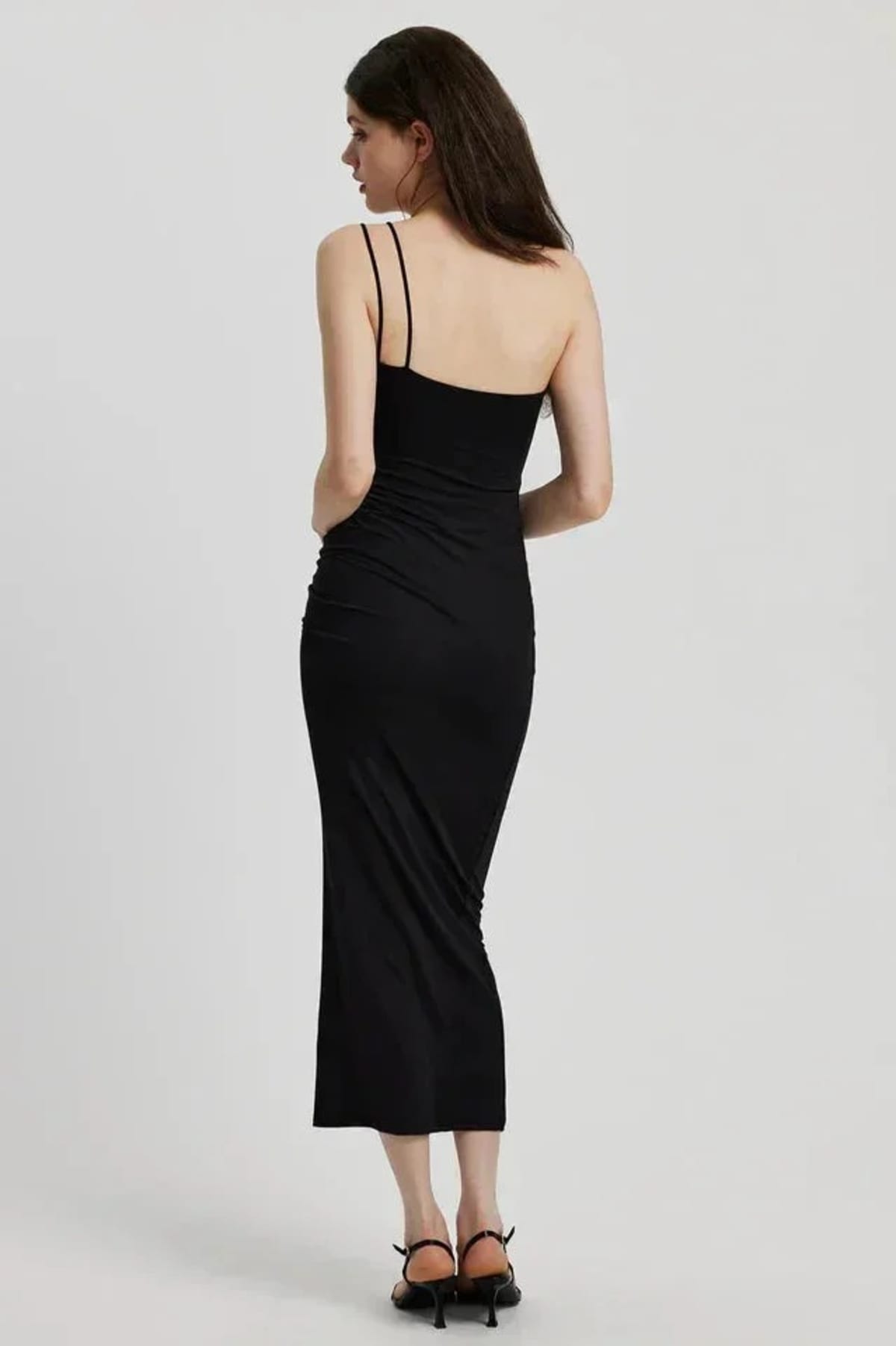 Model in bodycon midi dress with ruched bodice, asymmetric strap, 3D flower.