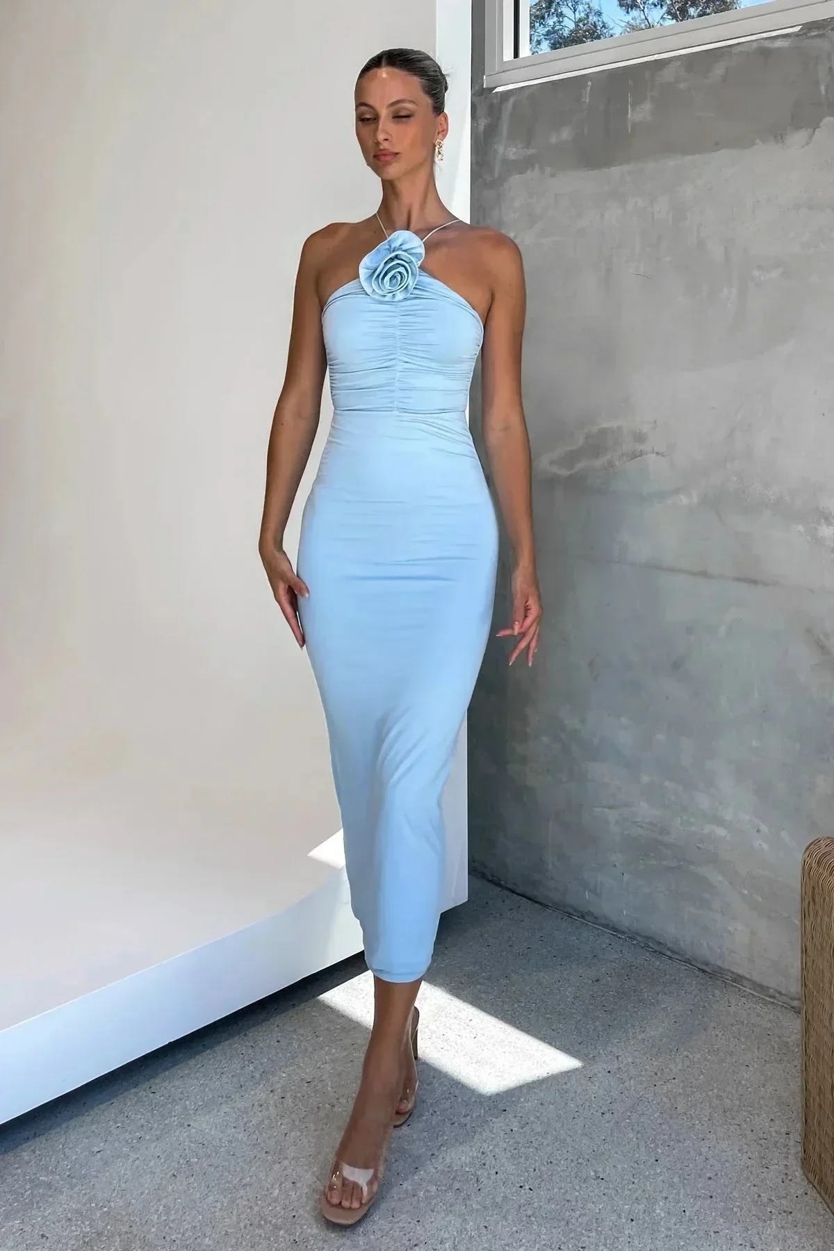Model in bodycon midi dress with ruched bodice, asymmetric strap, 3D flower.
