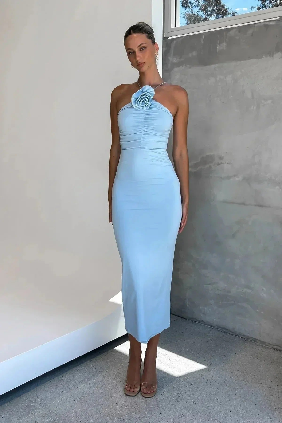 Model in bodycon midi dress with ruched bodice, asymmetric strap, 3D flower.