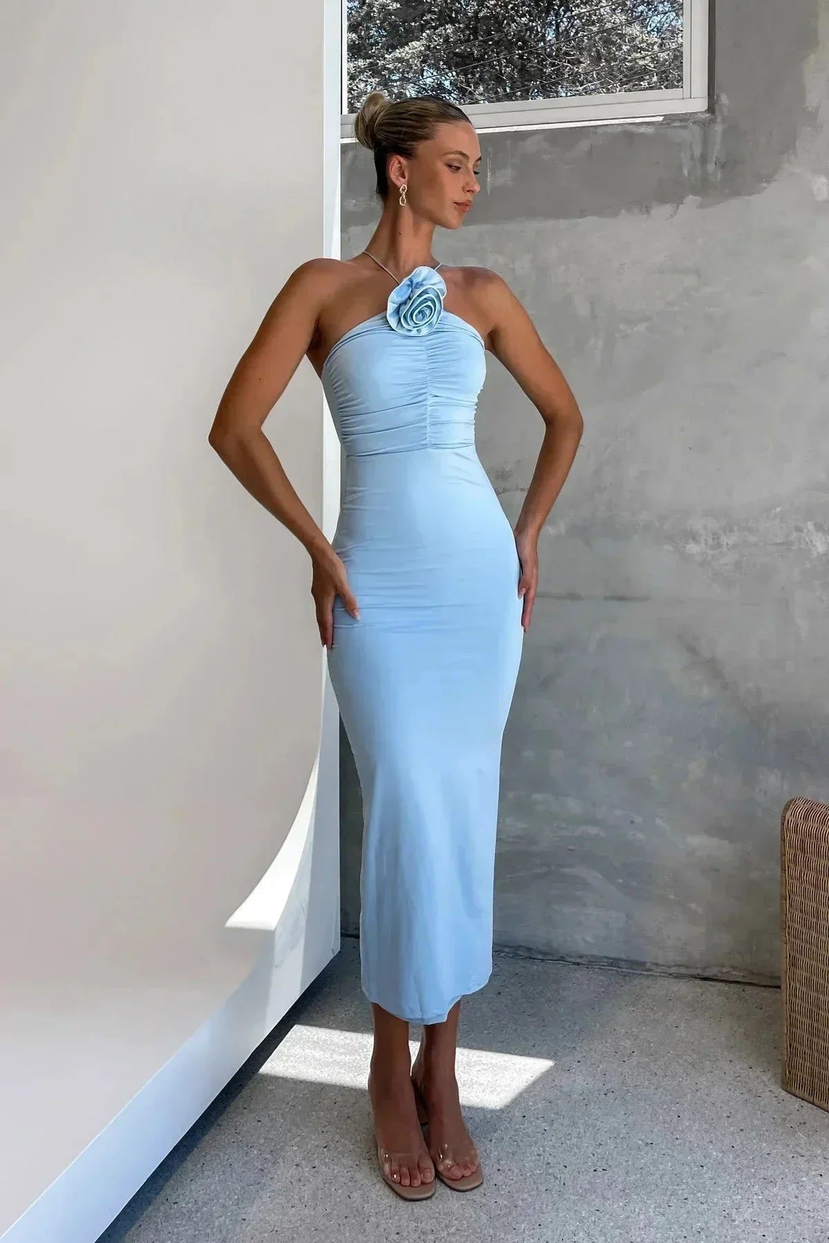 Model in bodycon midi dress with ruched bodice, asymmetric strap, 3D flower.