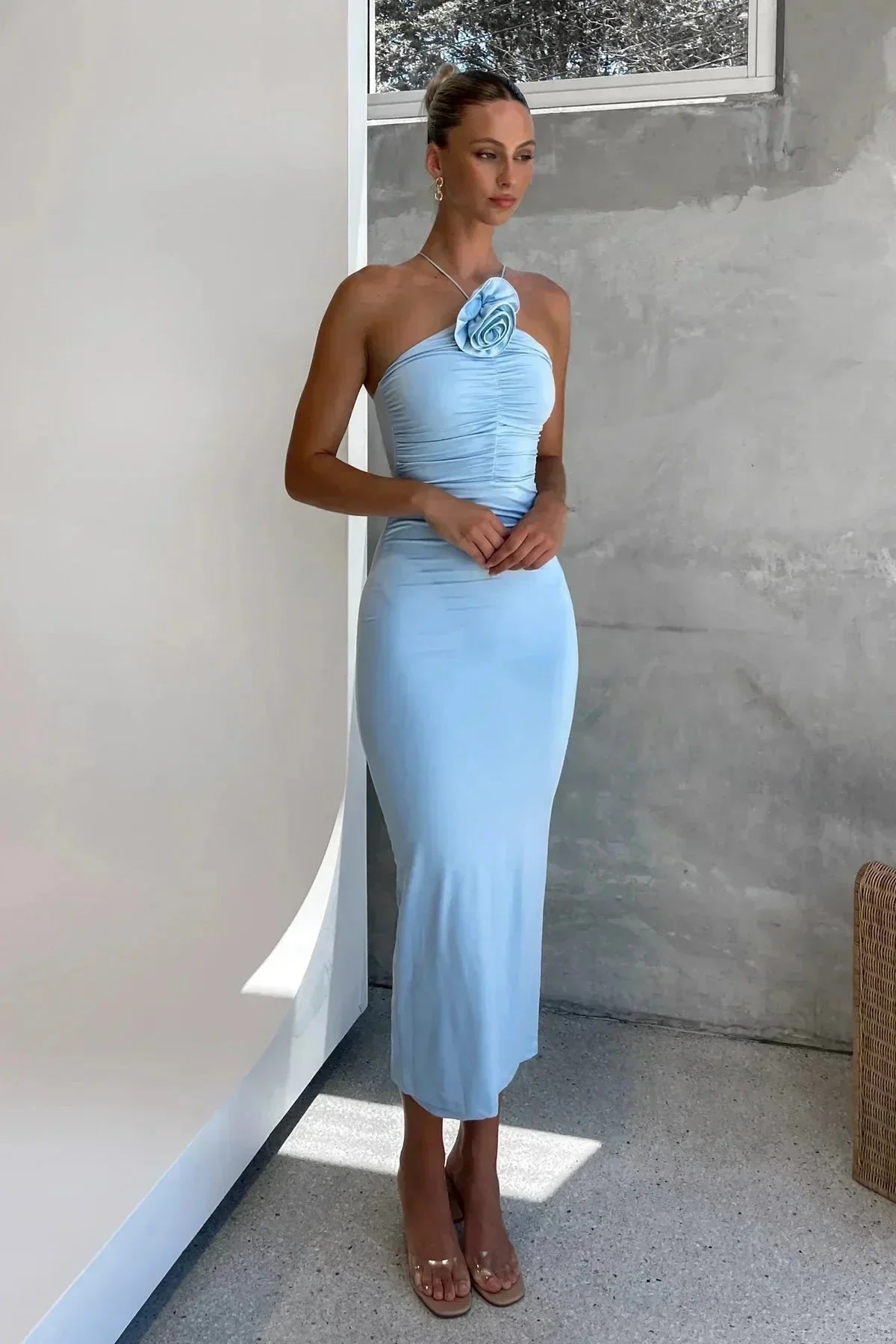 Model in bodycon midi dress with ruched bodice, asymmetric strap, 3D flower.