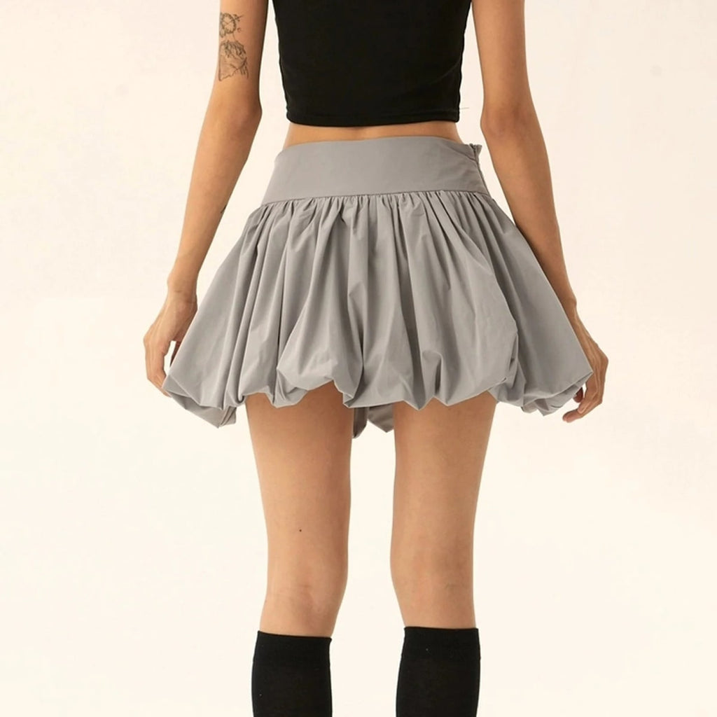 Model wearing a puffy mini skirt with bubble silhouette and high waist.