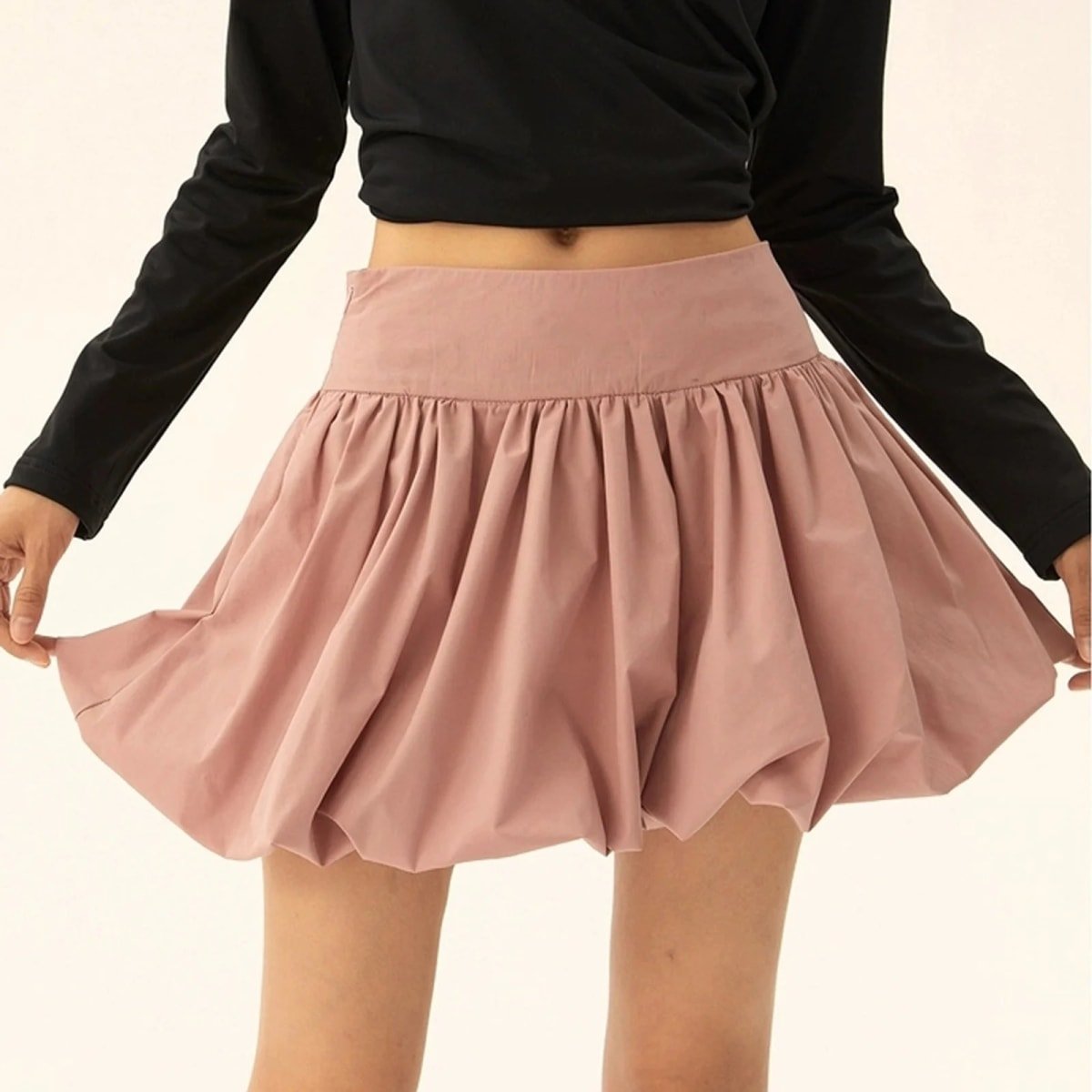 Model wearing a puffy mini skirt with bubble silhouette and high waist.