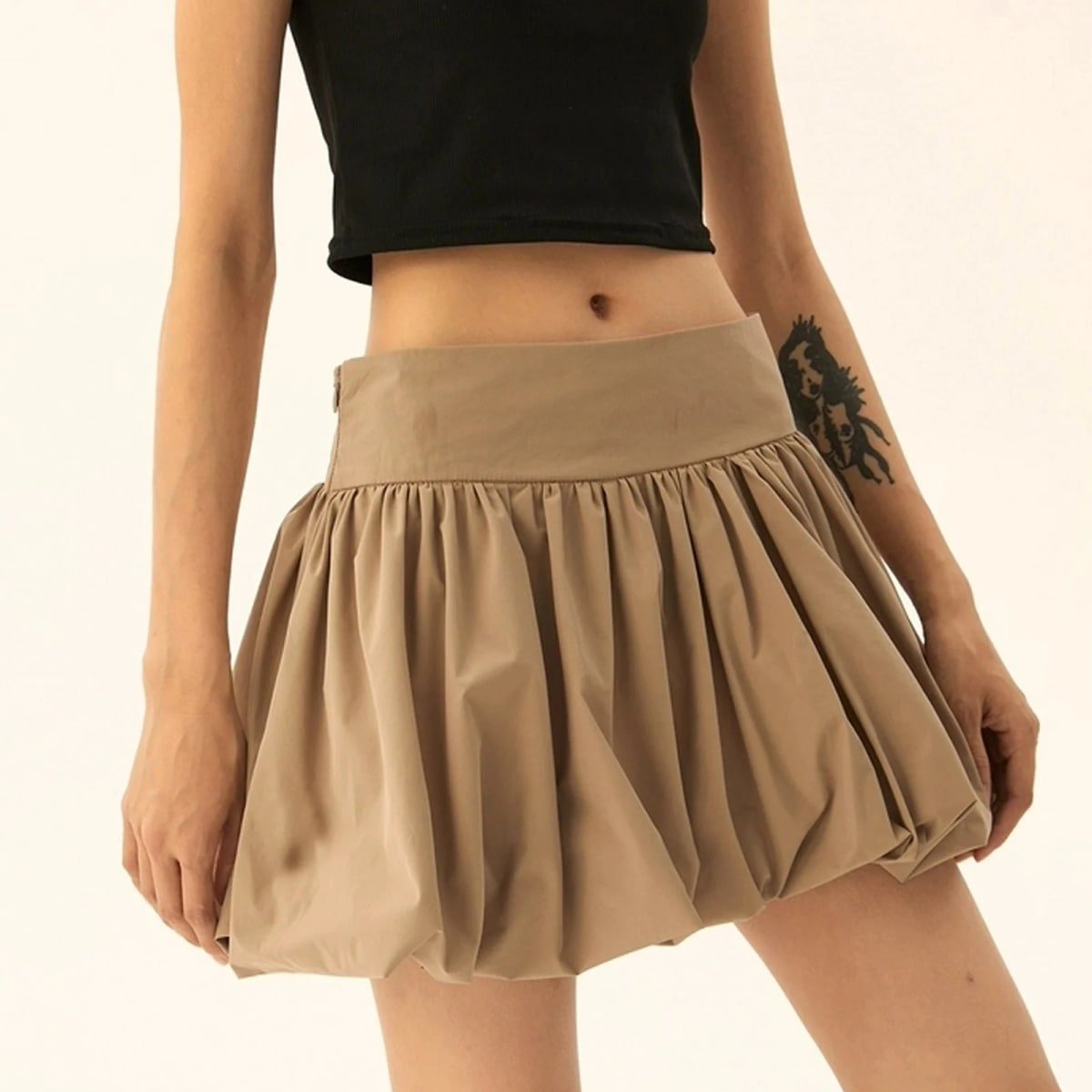 Model wearing a puffy mini skirt with bubble silhouette and high waist.