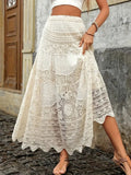 Woman sitting wearing crochet lace maxi skirt and crop top with bohemian jewelry.
