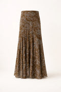 Woman wearing paisley midi skirt with flared hem and high waist.