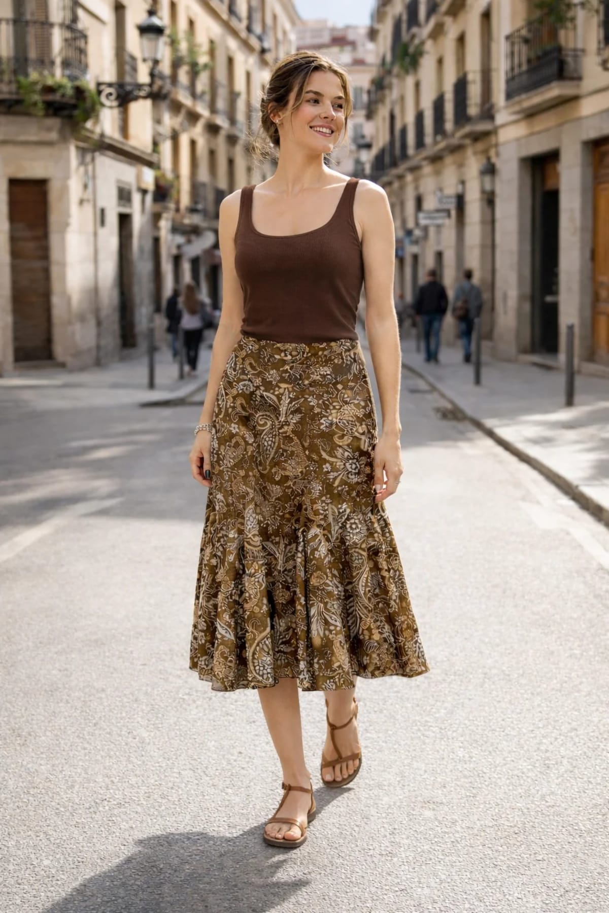 Woman wearing paisley midi skirt with flared hem and high waist.
