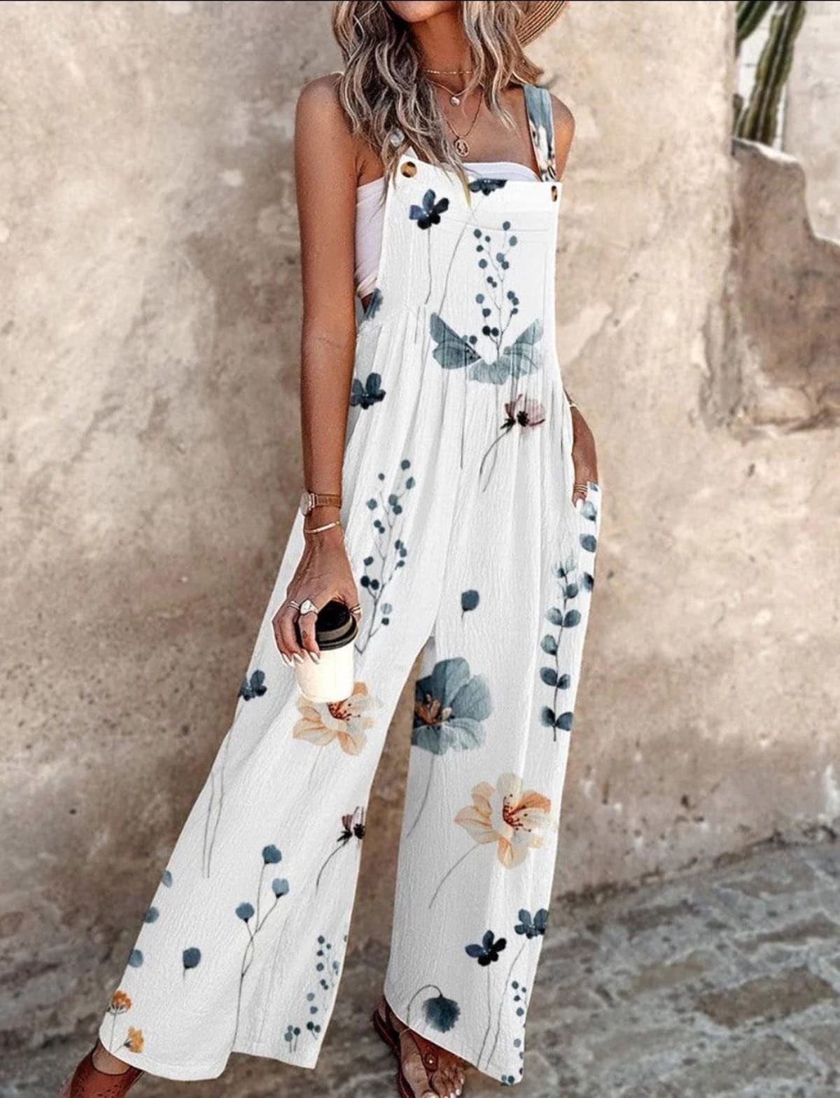 Sleeveless wide-leg jumpsuit with floral print and adjustable straps.