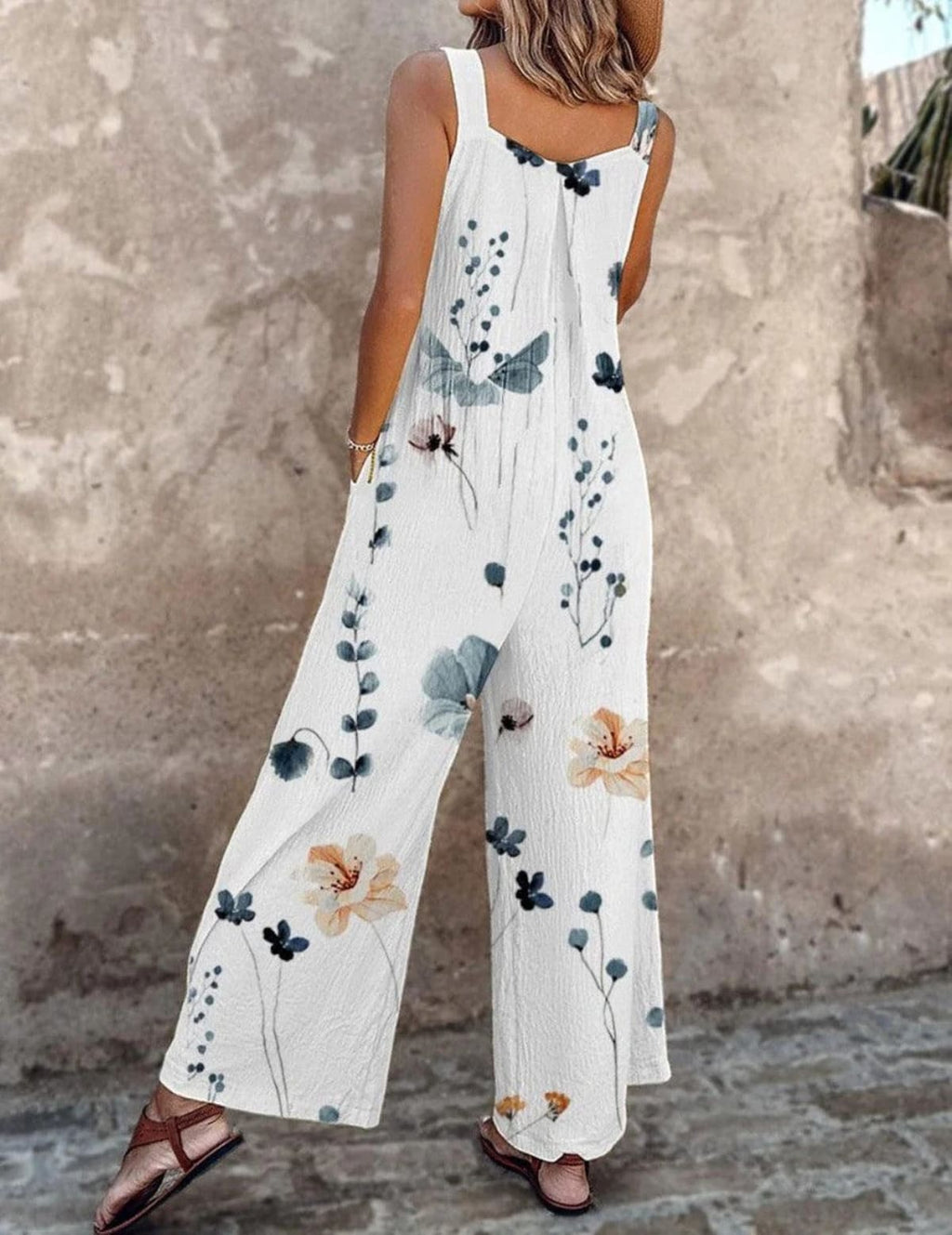 Sleeveless wide-leg jumpsuit with floral print and adjustable straps.