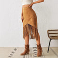 Woman wearing a midi skirt with fringe trim and asymmetrical hem.