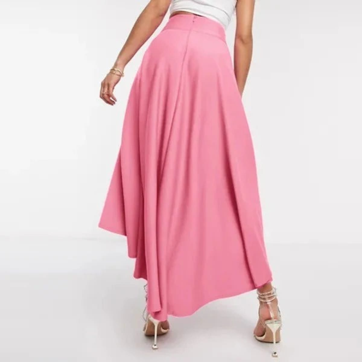 Model wearing high-waisted flared high-low midi skirt.