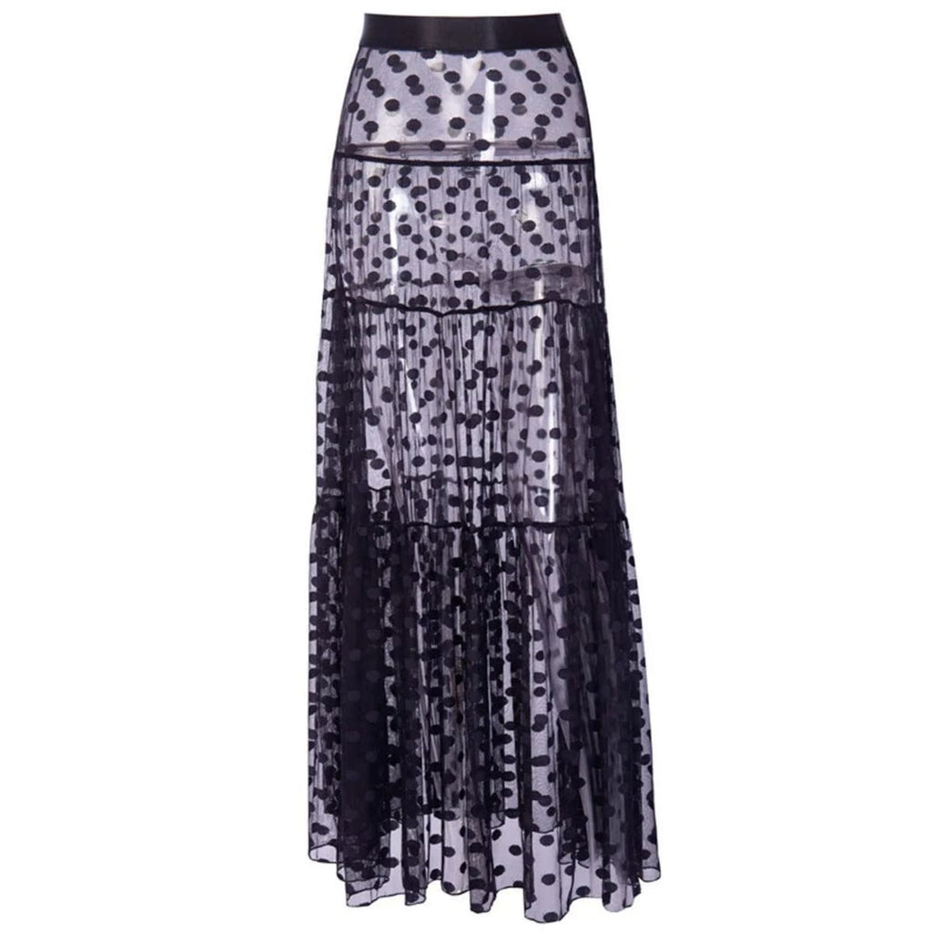 Model wearing a sheer polka dot maxi skirt with bandeau crop top.
