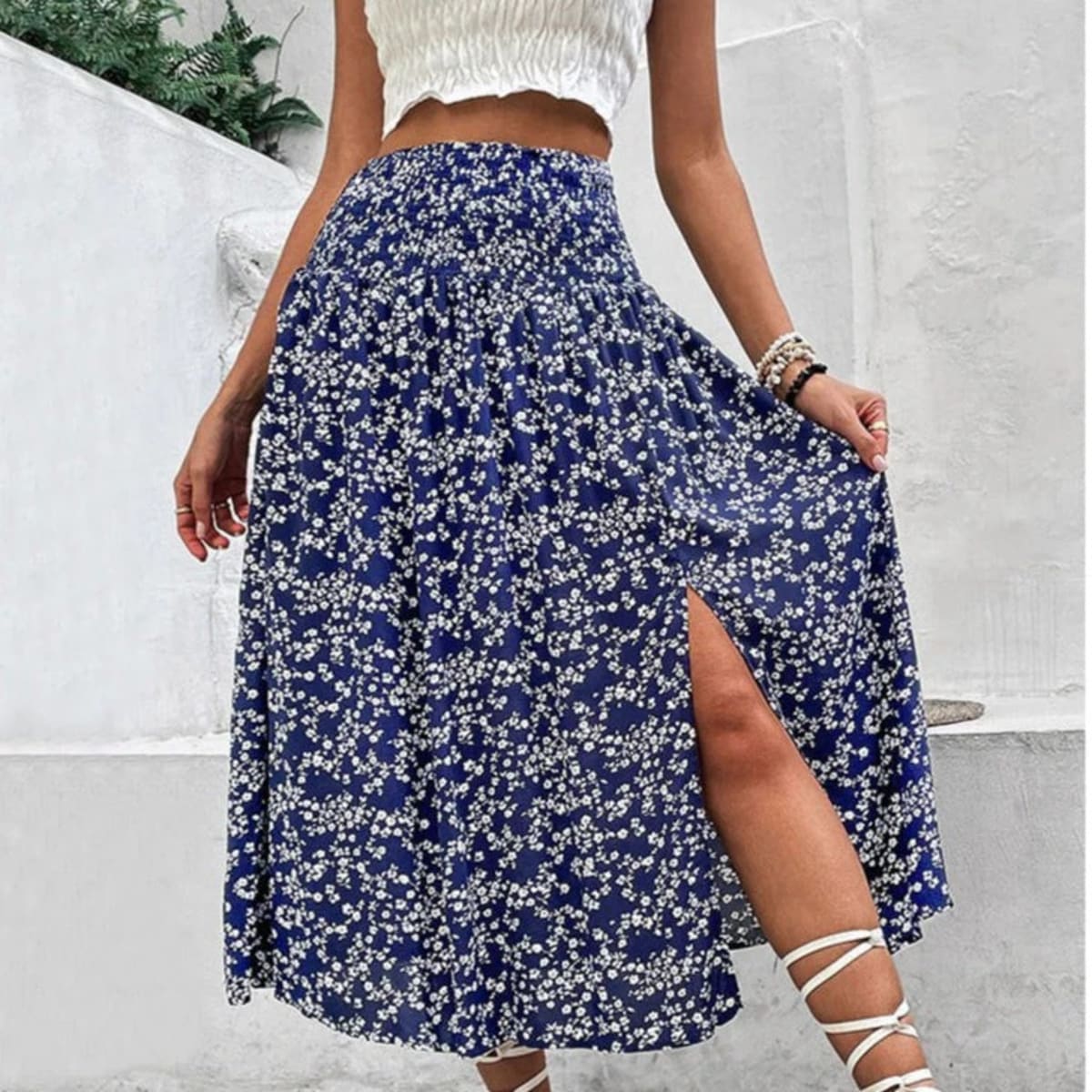 Woman wearing a navy floral midi skirt with smocked waist