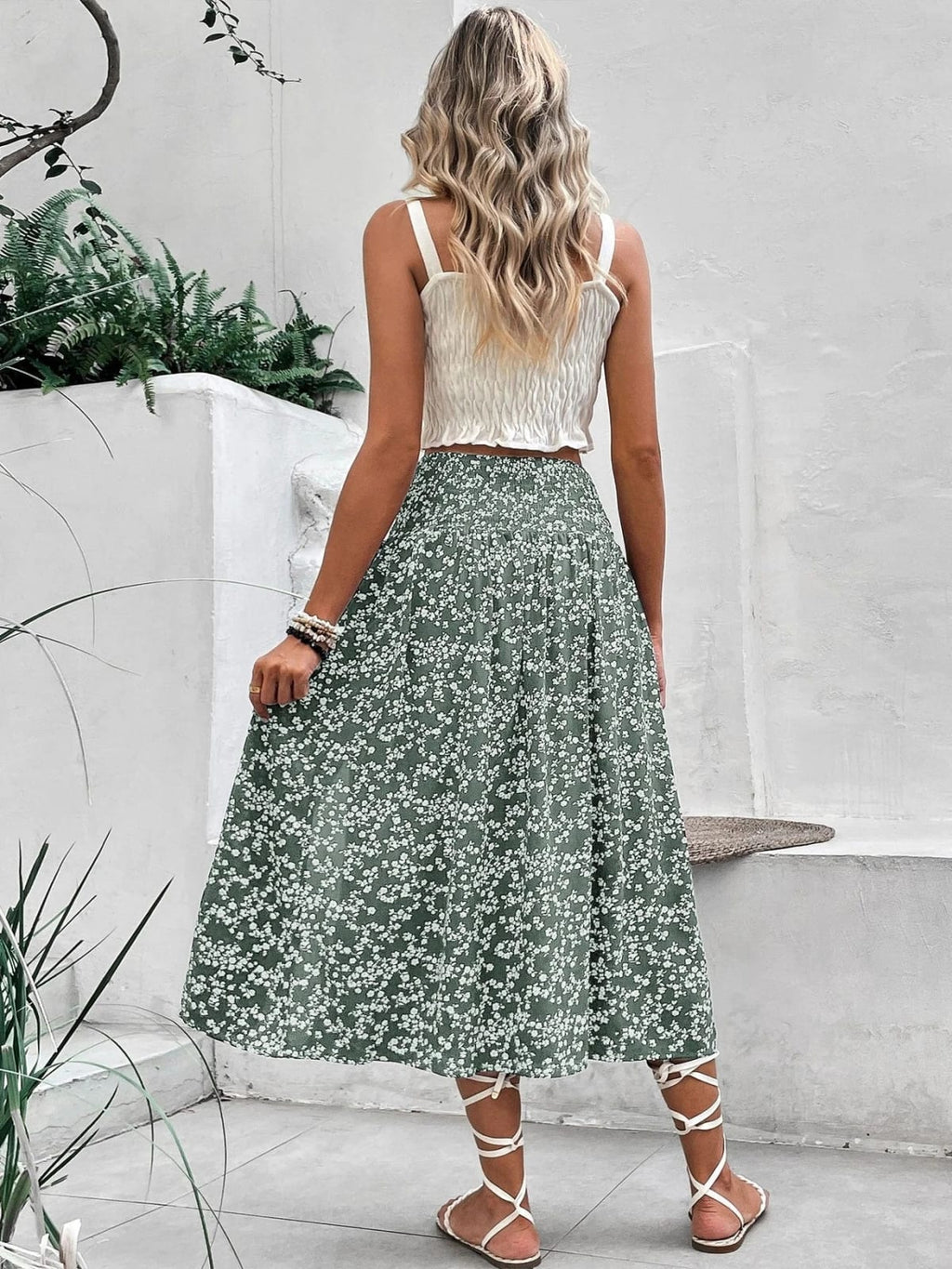 Woman wearing a navy floral midi skirt with smocked waist