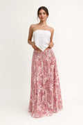Woman in strapless crop top and tiered maxi skirt set.
