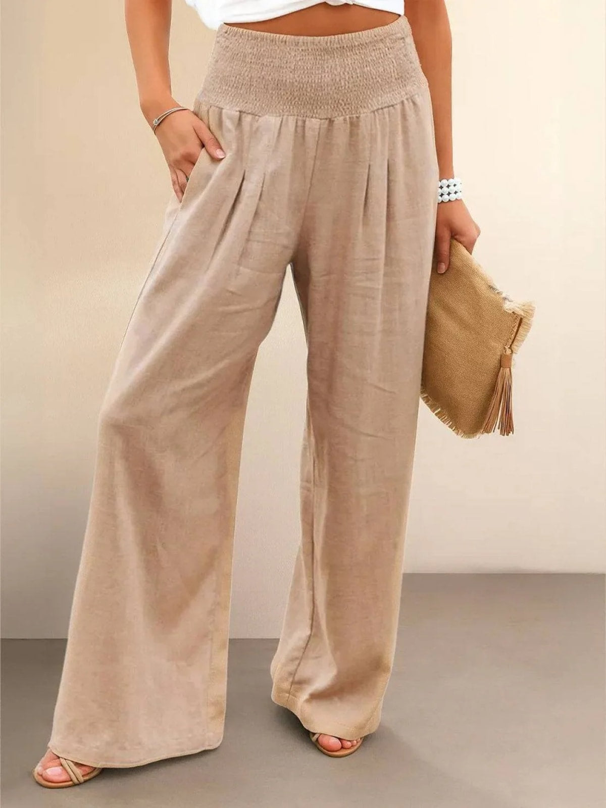 Women's high-waist wide-leg pants with smocked waistband.