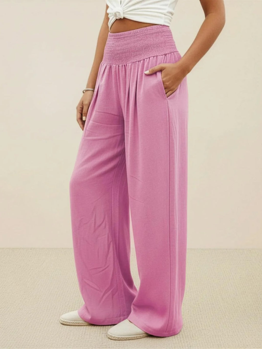 Women's high-waist wide-leg pants with smocked waistband.