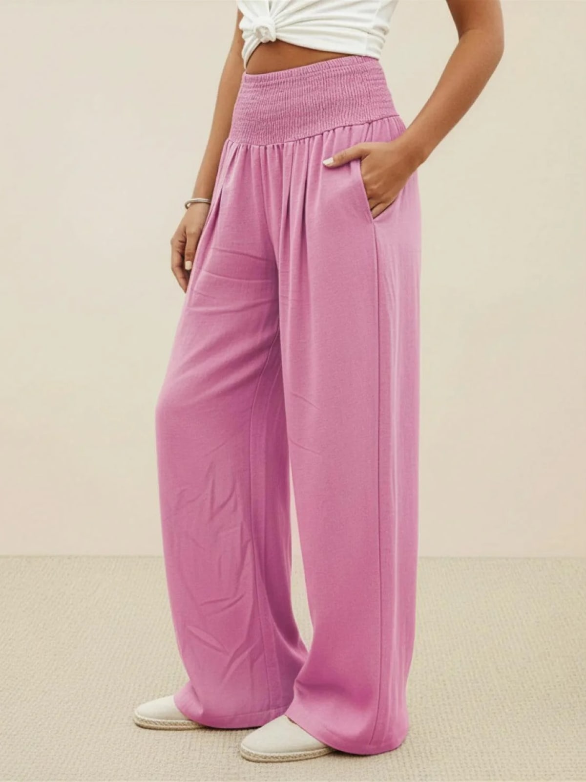 Women's high-waist wide-leg pants with smocked waistband.