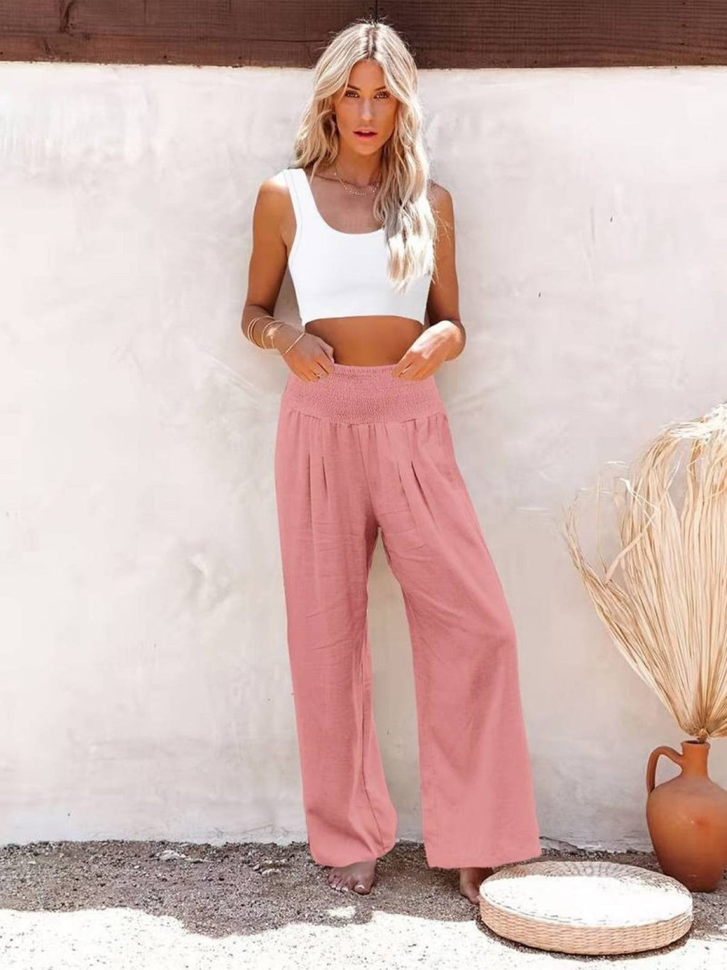 Women's high-waist wide-leg pants with smocked waistband.