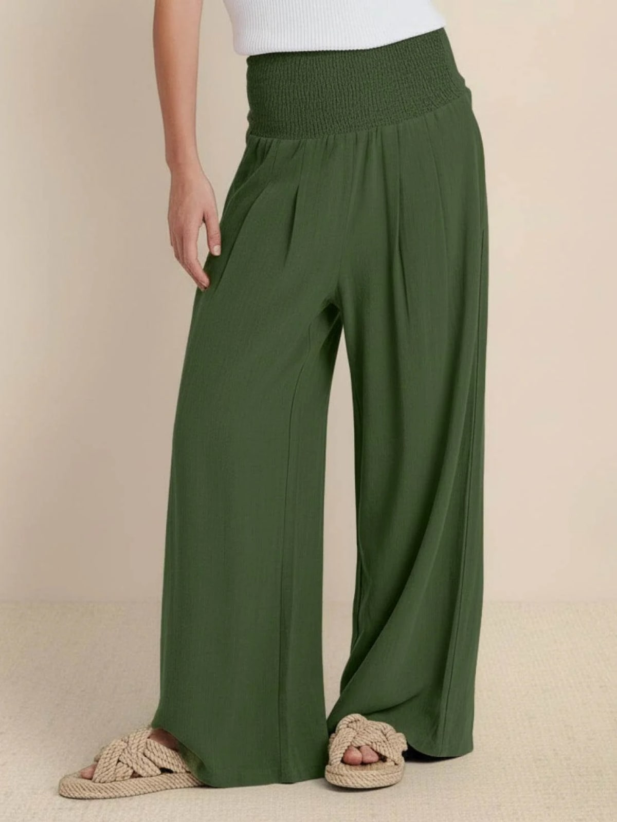 Women's high-waist wide-leg pants with smocked waistband.