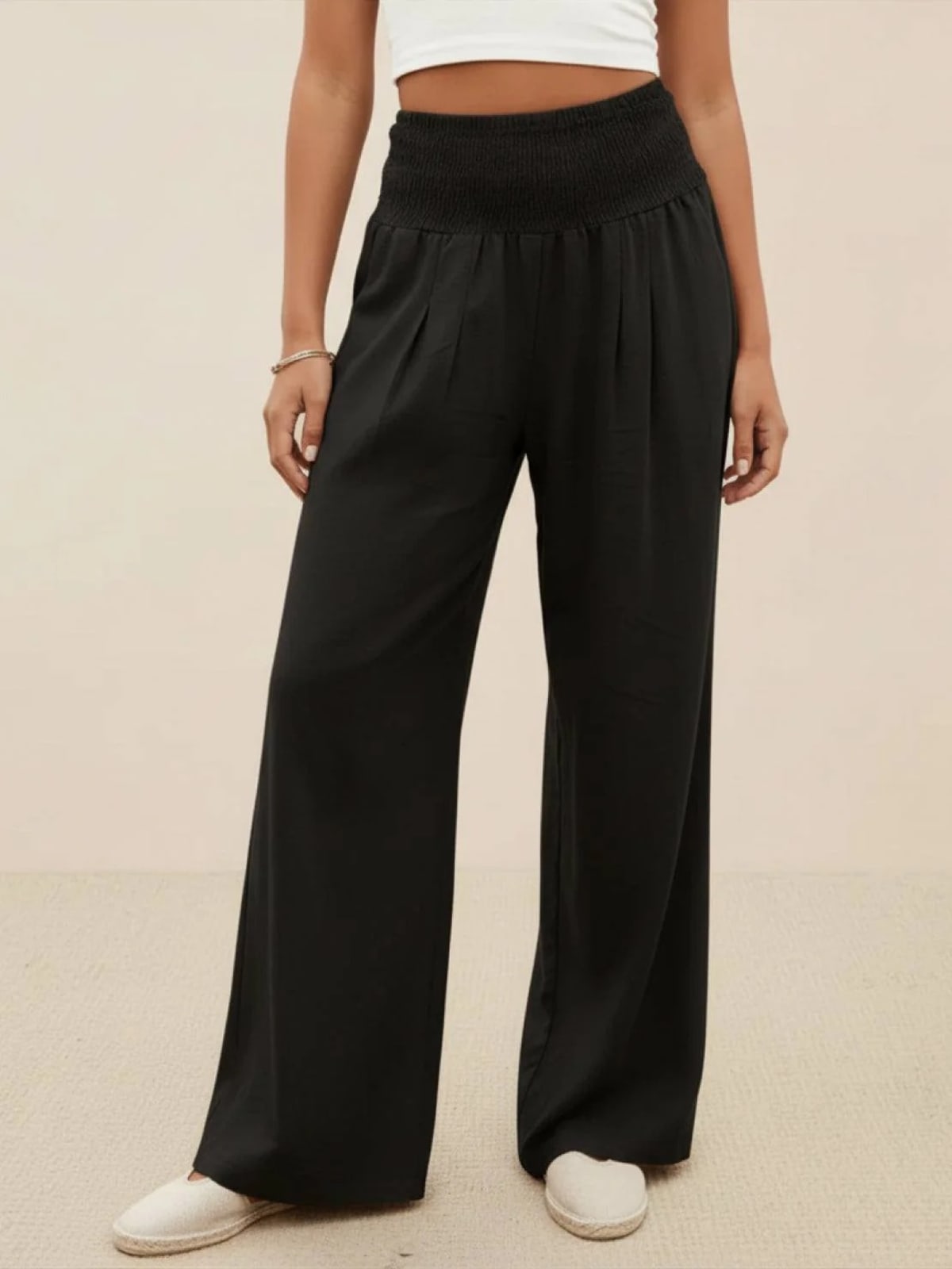 Women's high-waist wide-leg pants with smocked waistband.