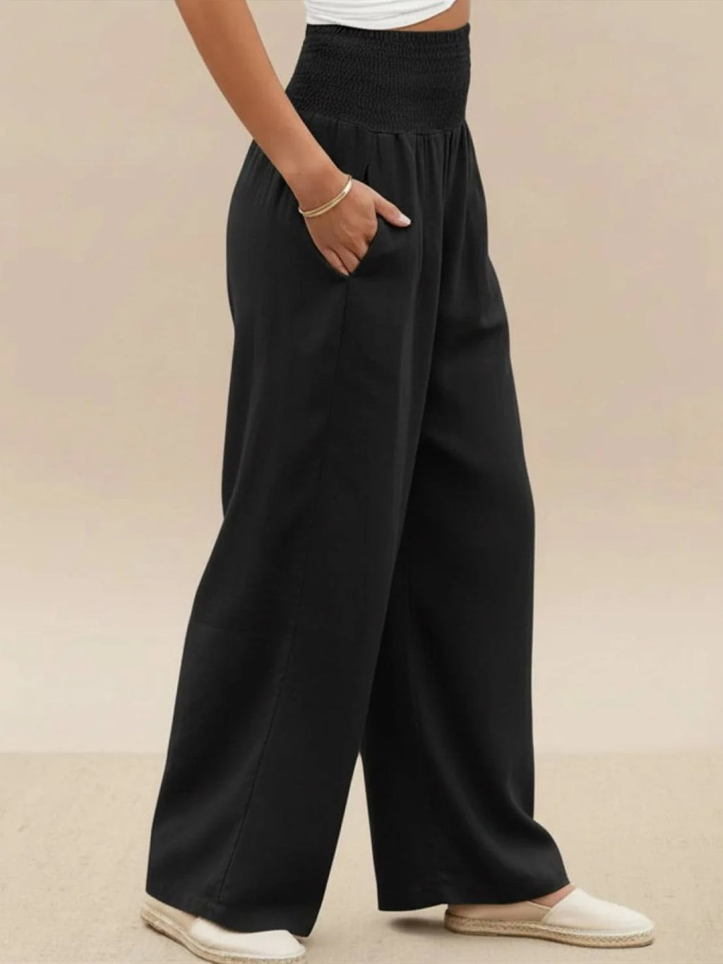 Women's high-waist wide-leg pants with smocked waistband.