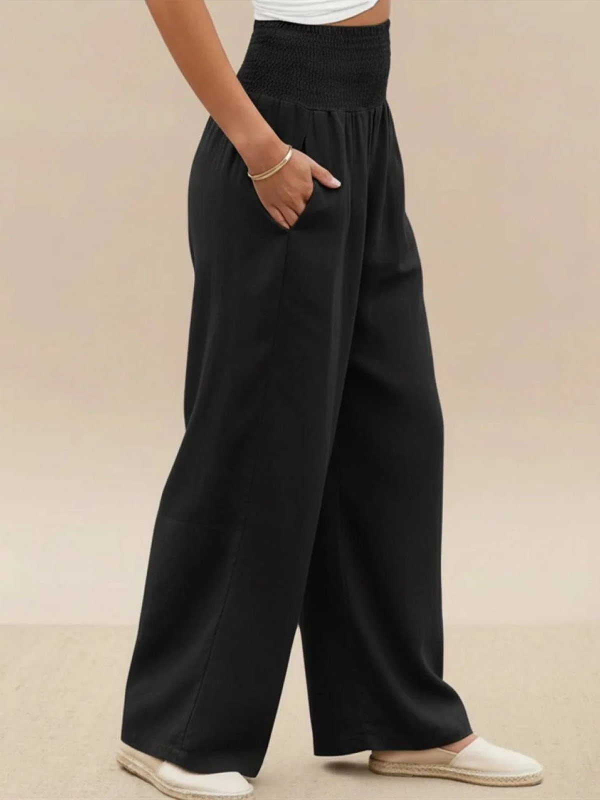Women's high-waist wide-leg pants with smocked waistband.