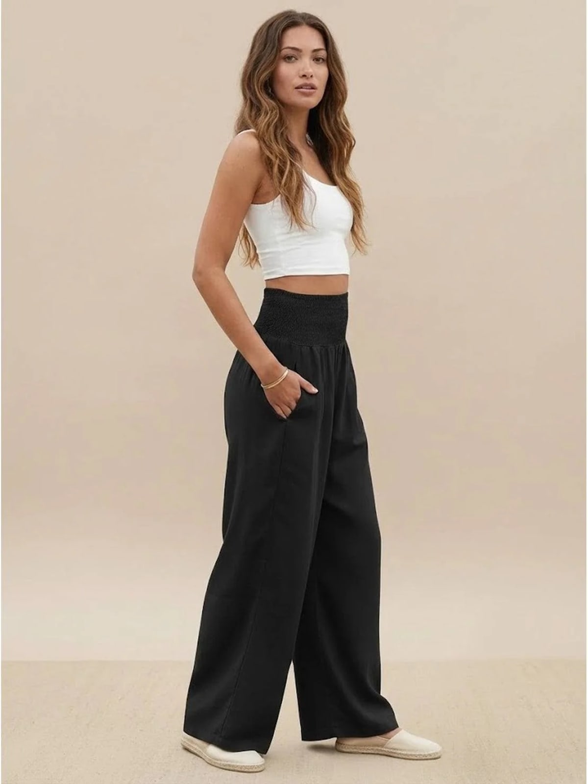 Women's high-waist wide-leg pants with smocked waistband.