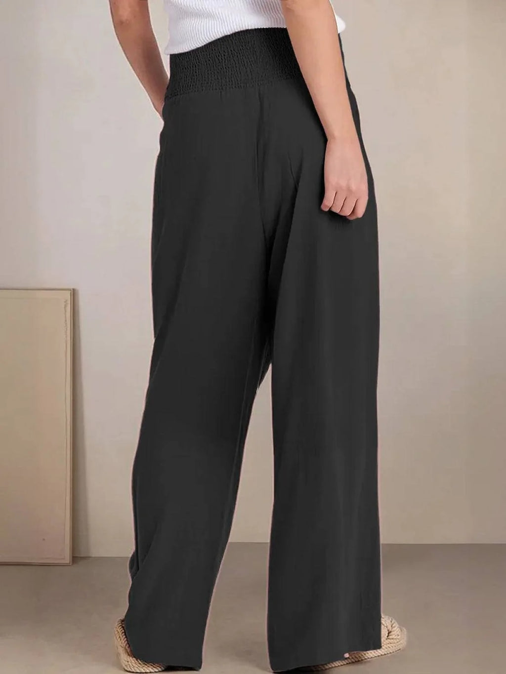Women's high-waist wide-leg pants with smocked waistband.