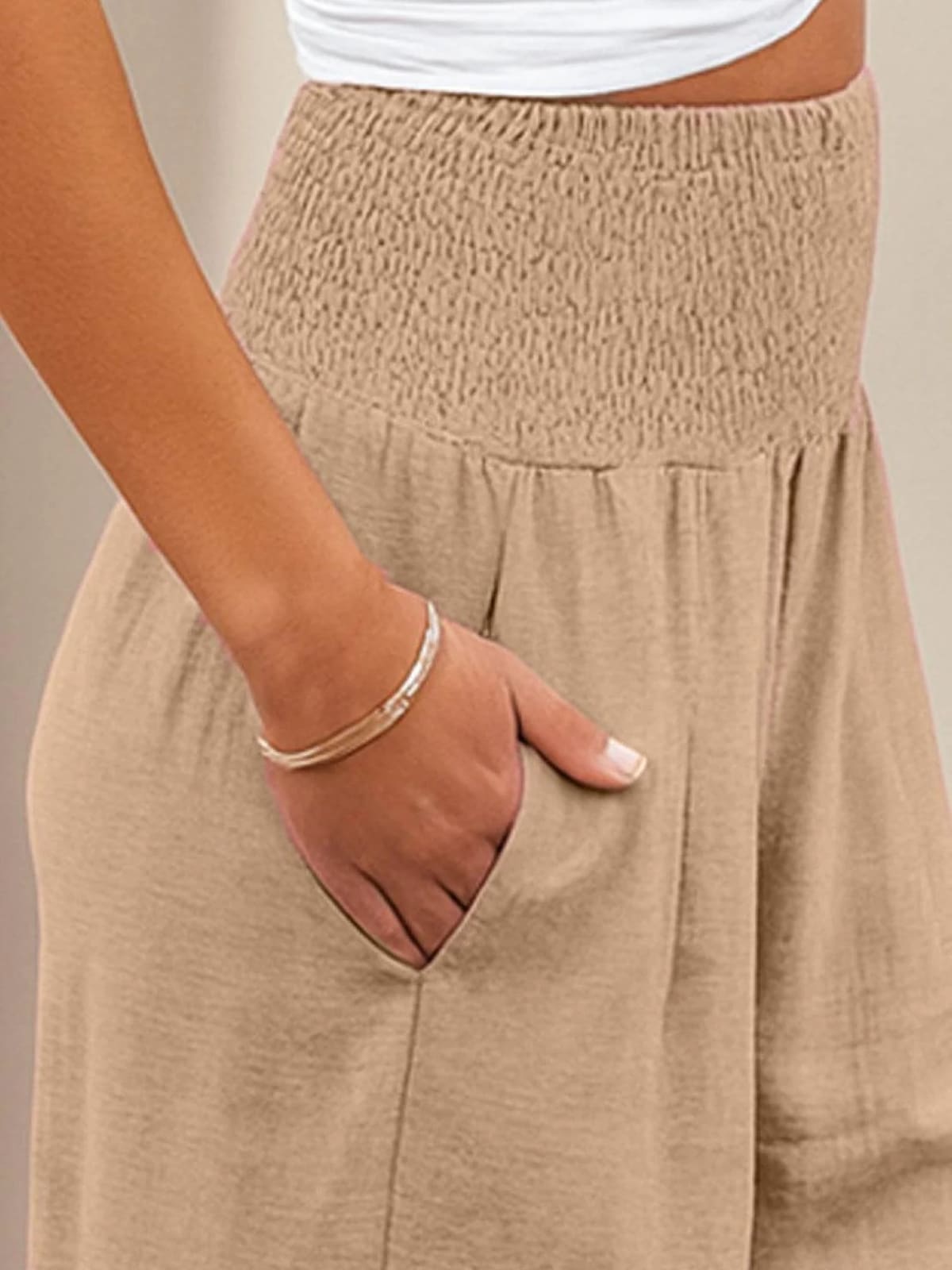 Women's high-waist wide-leg pants with smocked waistband.