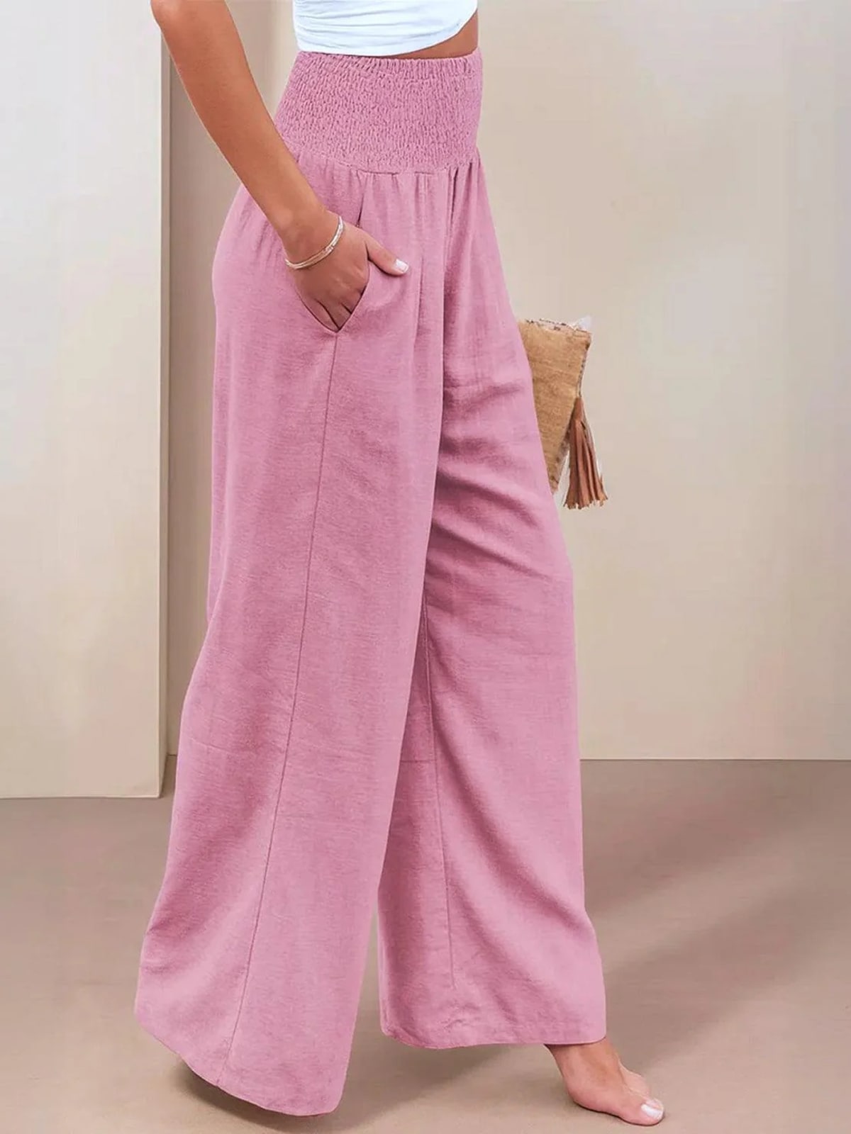 Women's high-waist wide-leg pants with smocked waistband.