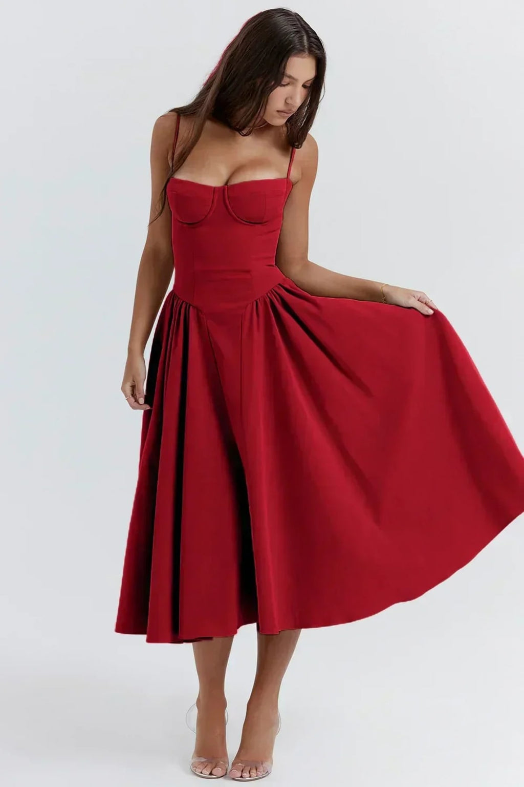 Woman in strapless midi dress with corset bodice and flowy skirt.