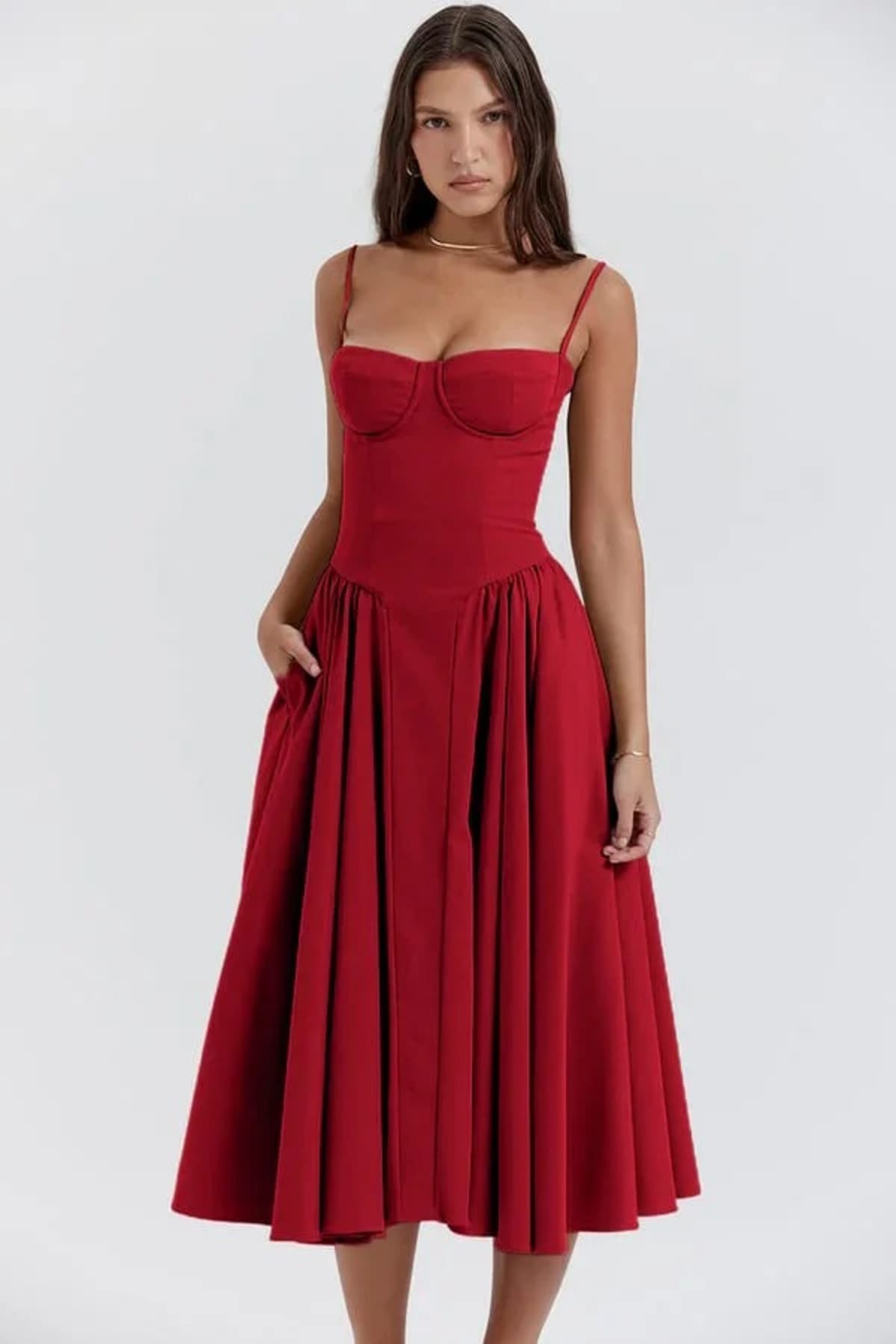 Woman in strapless midi dress with corset bodice and flowy skirt.