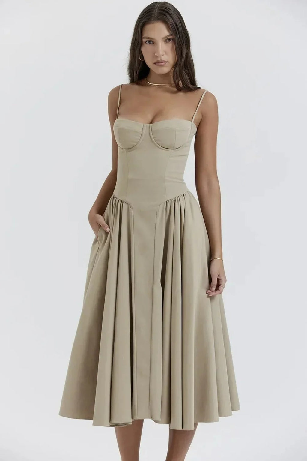 Woman in strapless midi dress with corset bodice and flowy skirt.