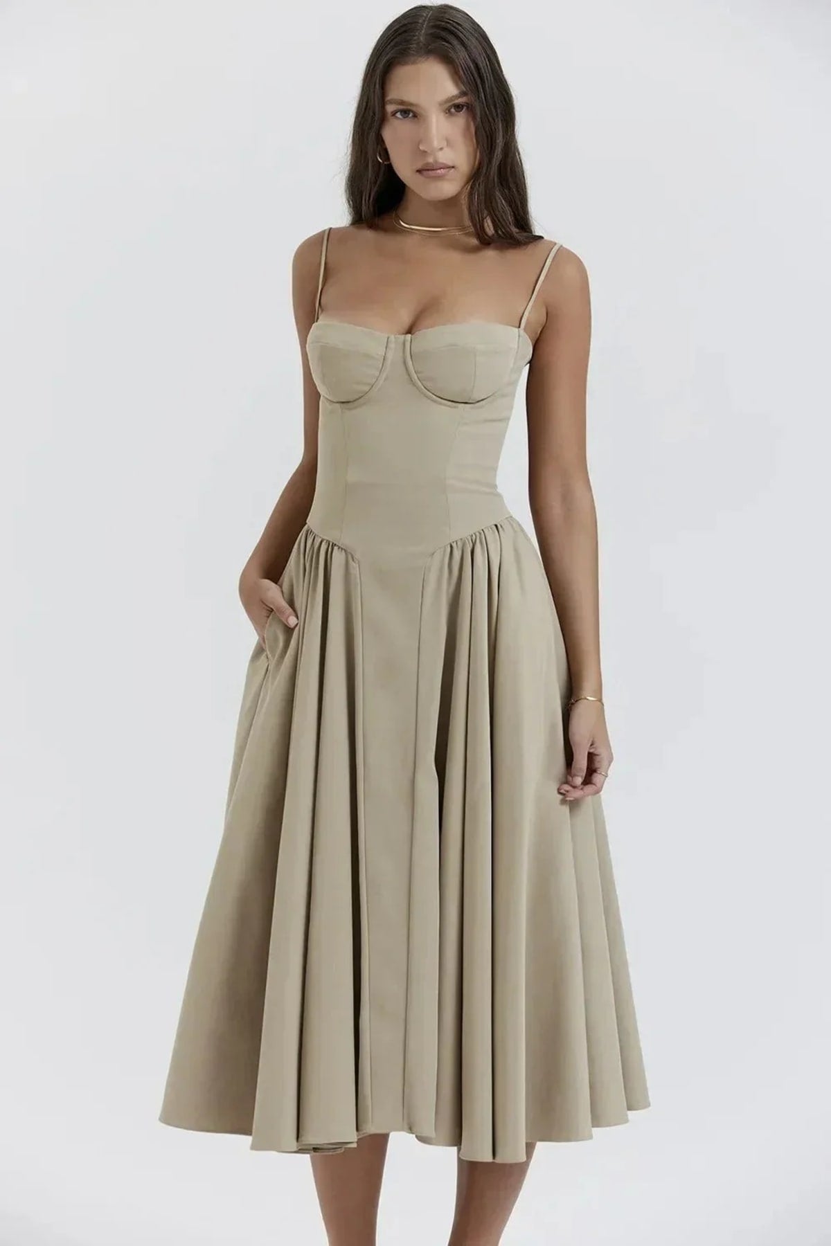 Woman in strapless midi dress with corset bodice and flowy skirt.