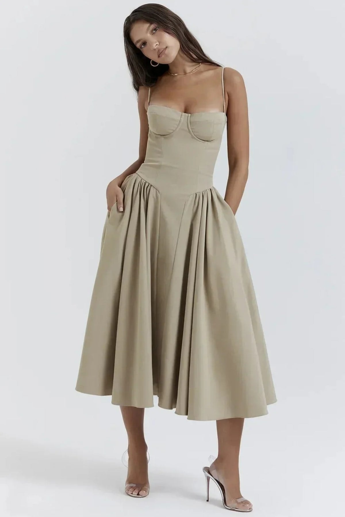 Woman in strapless midi dress with corset bodice and flowy skirt.