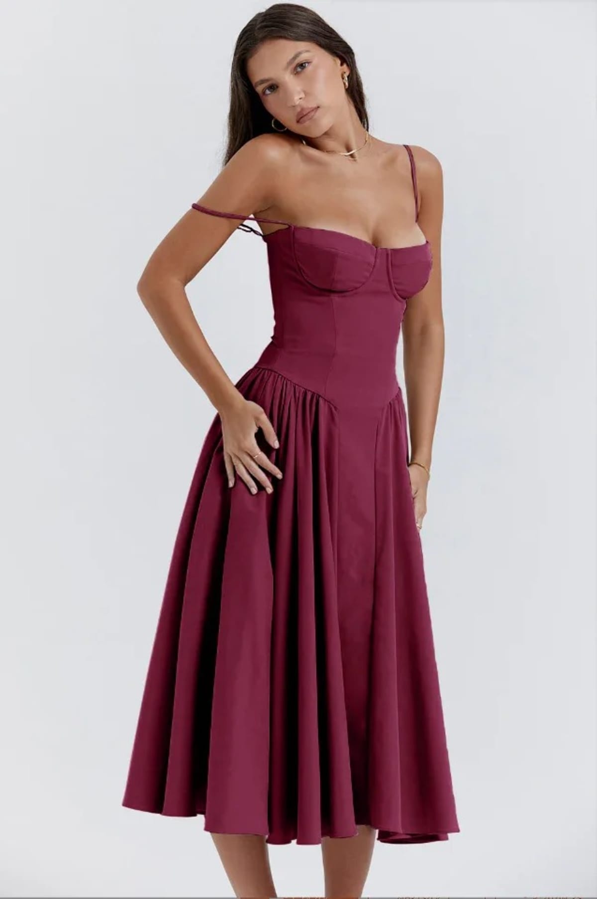 Woman in strapless midi dress with corset bodice and flowy skirt.