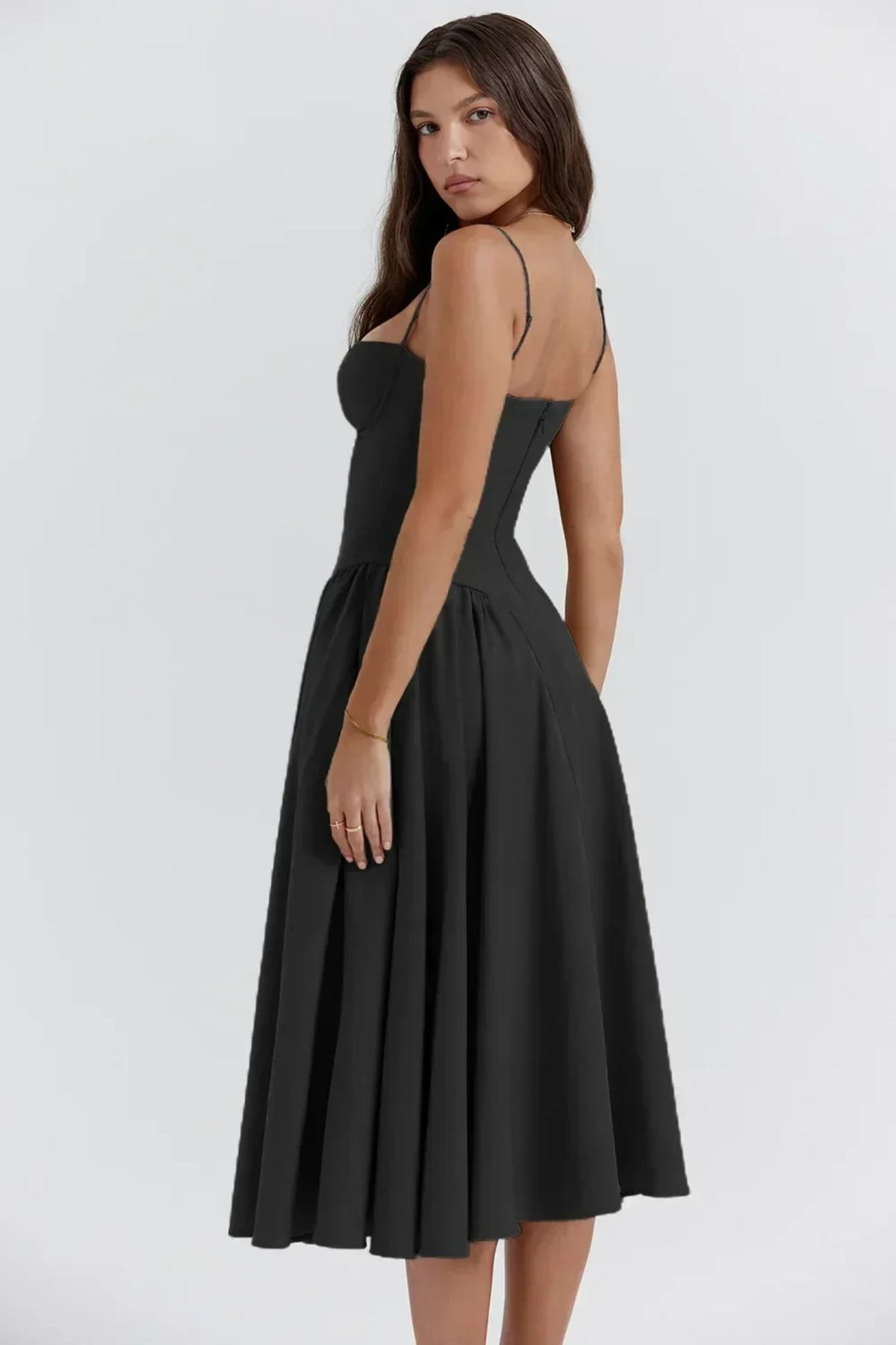 Woman in strapless midi dress with corset bodice and flowy skirt.