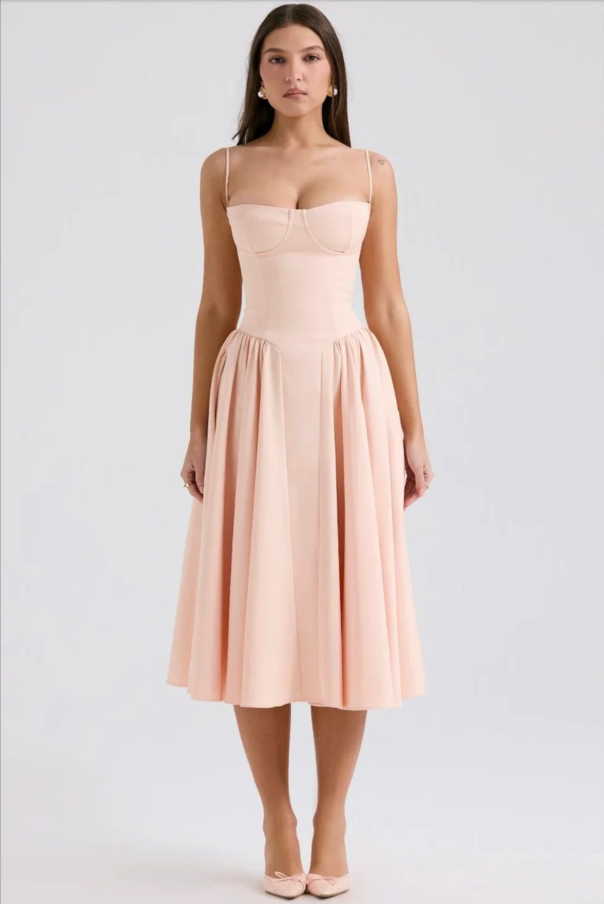 Woman in strapless midi dress with corset bodice and flowy skirt.