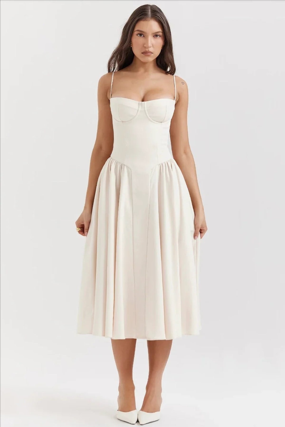 Woman in strapless midi dress with corset bodice and flowy skirt.