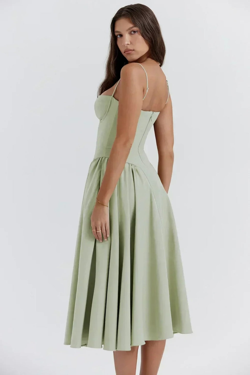 Woman in strapless midi dress with corset bodice and flowy skirt.