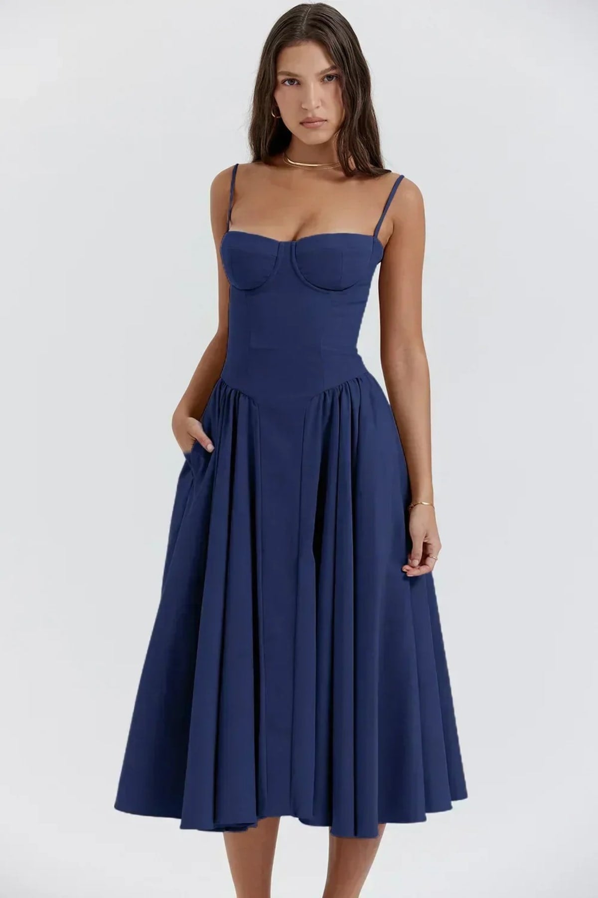 Woman in strapless midi dress with corset bodice and flowy skirt.