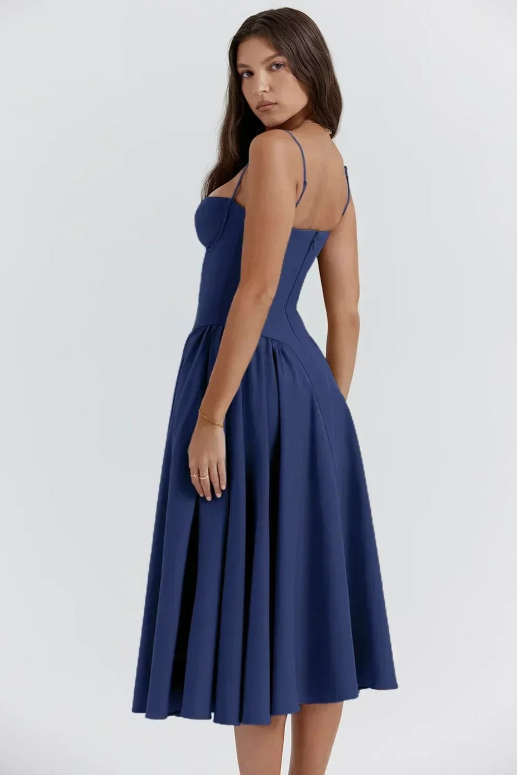 Woman in strapless midi dress with corset bodice and flowy skirt.