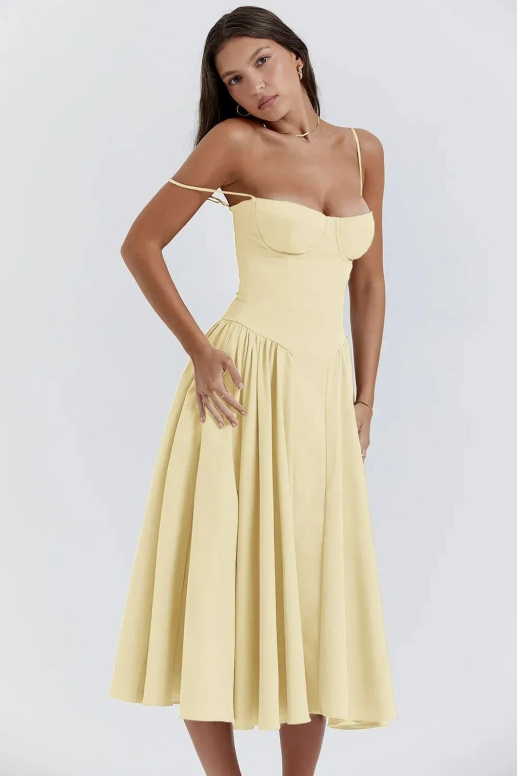 Woman in strapless midi dress with corset bodice and flowy skirt.